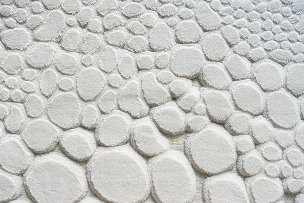 A balanced stack of smooth stones against a soft background.