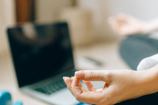A yoga mat rolled out in a peaceful, sunlit room.